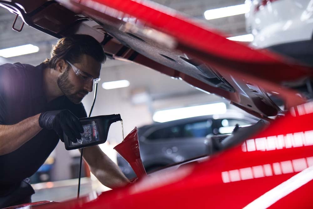 Service technician performs a Mazda oil change.