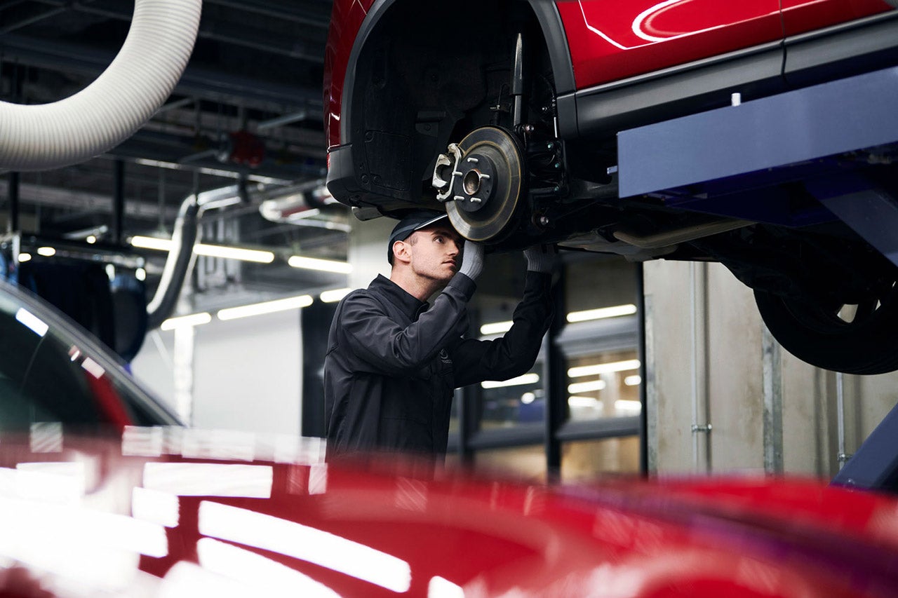 Mazda technician performs service on a Mazda car
