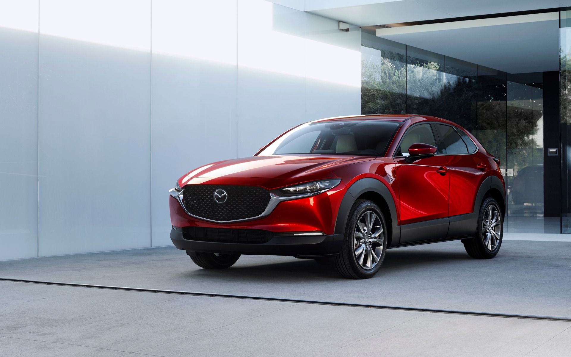 Image of a red 2020 Mazda CX-30 parked in front of a white house.