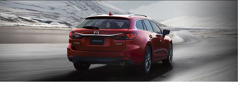 Image of a red Mazda SUV driving away on a highway.