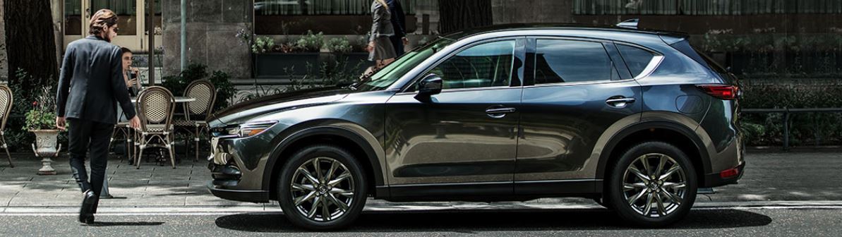 Image of a 2019 Mazda CX-5 Signature Diesel SUV parked on the street.