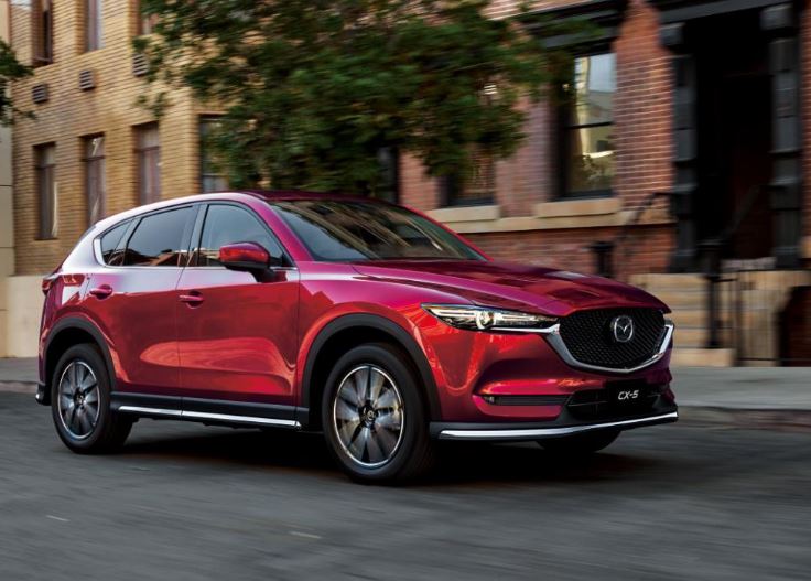 Image of a red 2019 Mazda CX-5 on a city street.