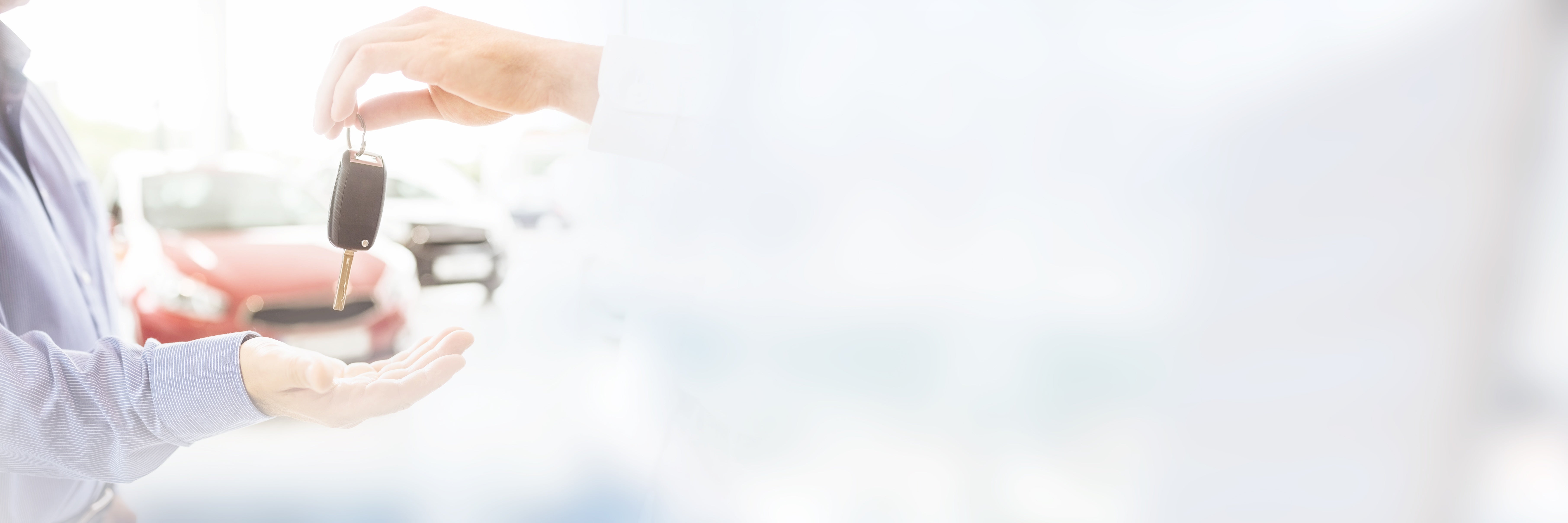 Outreached hand receiving keys to a new Mazda