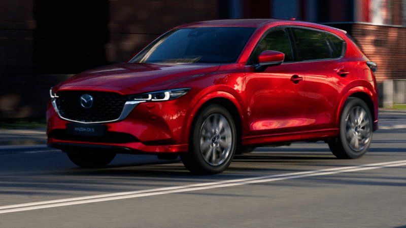 A shiny red 2022 Mazda CX-5 on a shady street